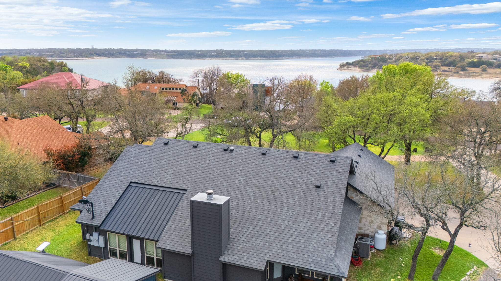 Aerial drone photograph of a residential home overlooking Lake Travis in Central Texas