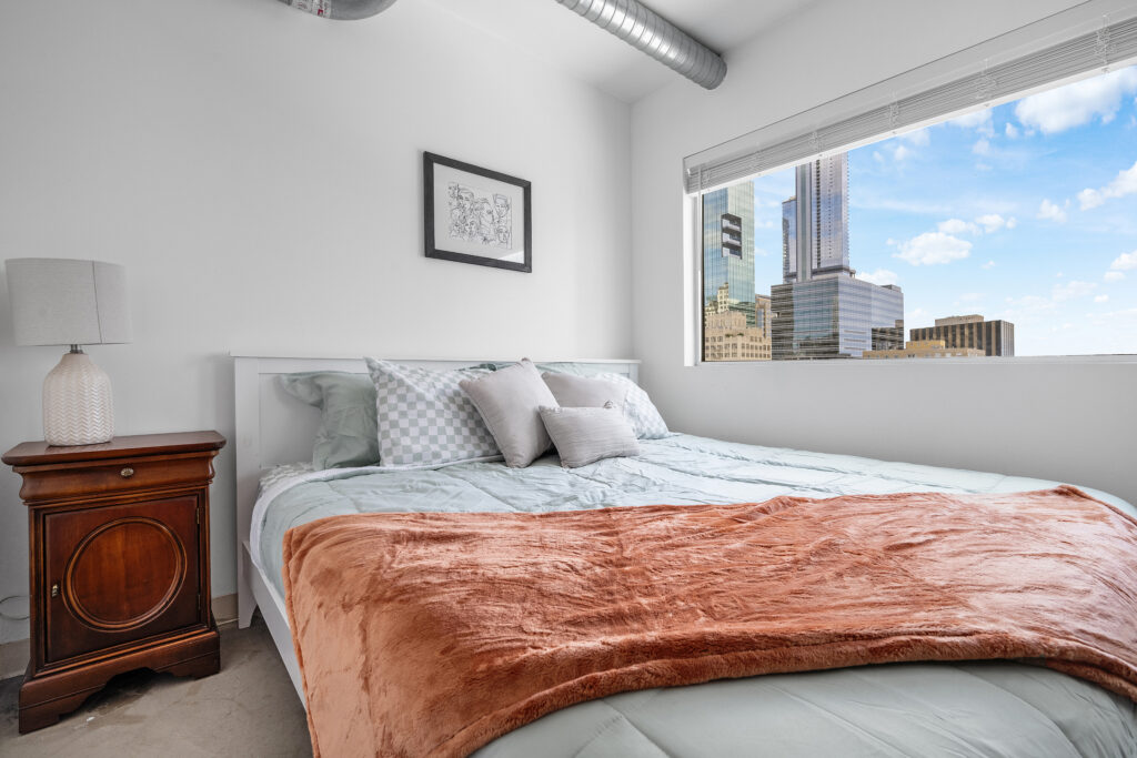Austin downtown condo interior real estate photographer showcasing a luxury primary bedroom with modern design, natural light, and professional interior photography.