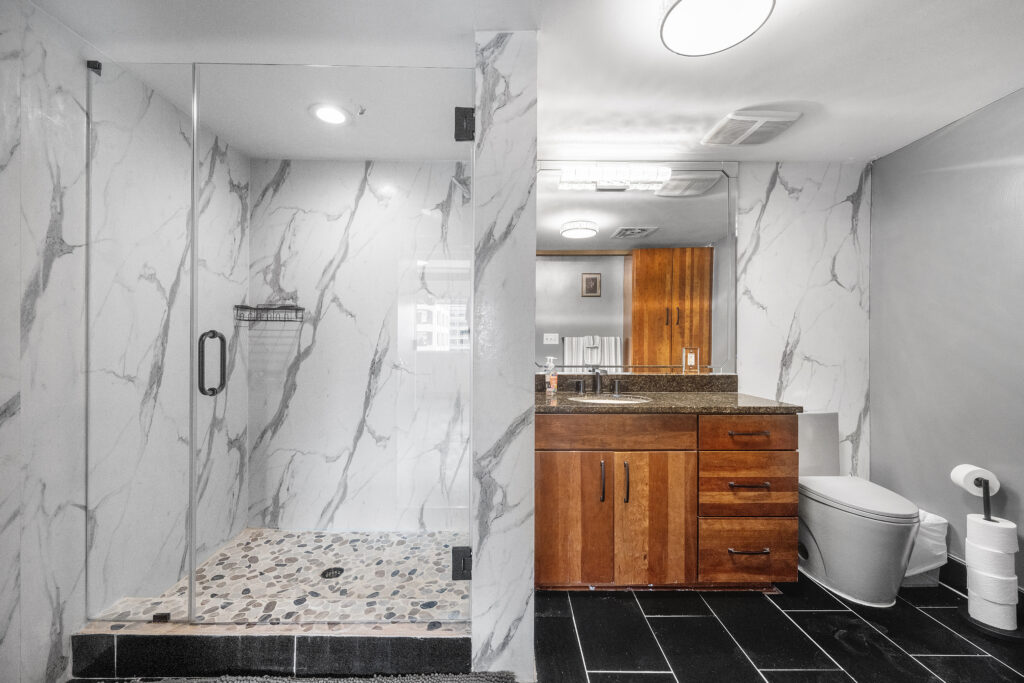 Austin real estate photographer showcasing a luxury downtown condominium bathroom with modern finishes, elegant fixtures, and professional interior photography.