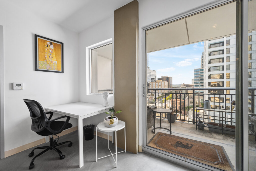 Austin real estate photography featuring a private downtown balcony with city views, modern outdoor living space, and professional exterior photography.
