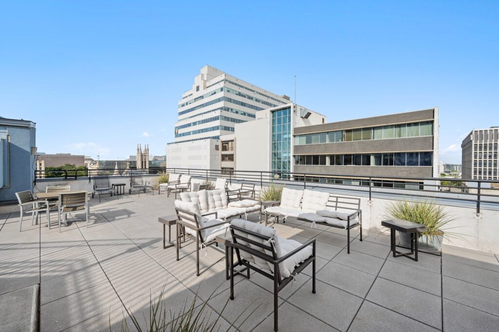 Austin real estate photography featuring a stylish sitting area with a balcony overlooking the rooftop, professionally photographed to highlight indoor-outdoor living.