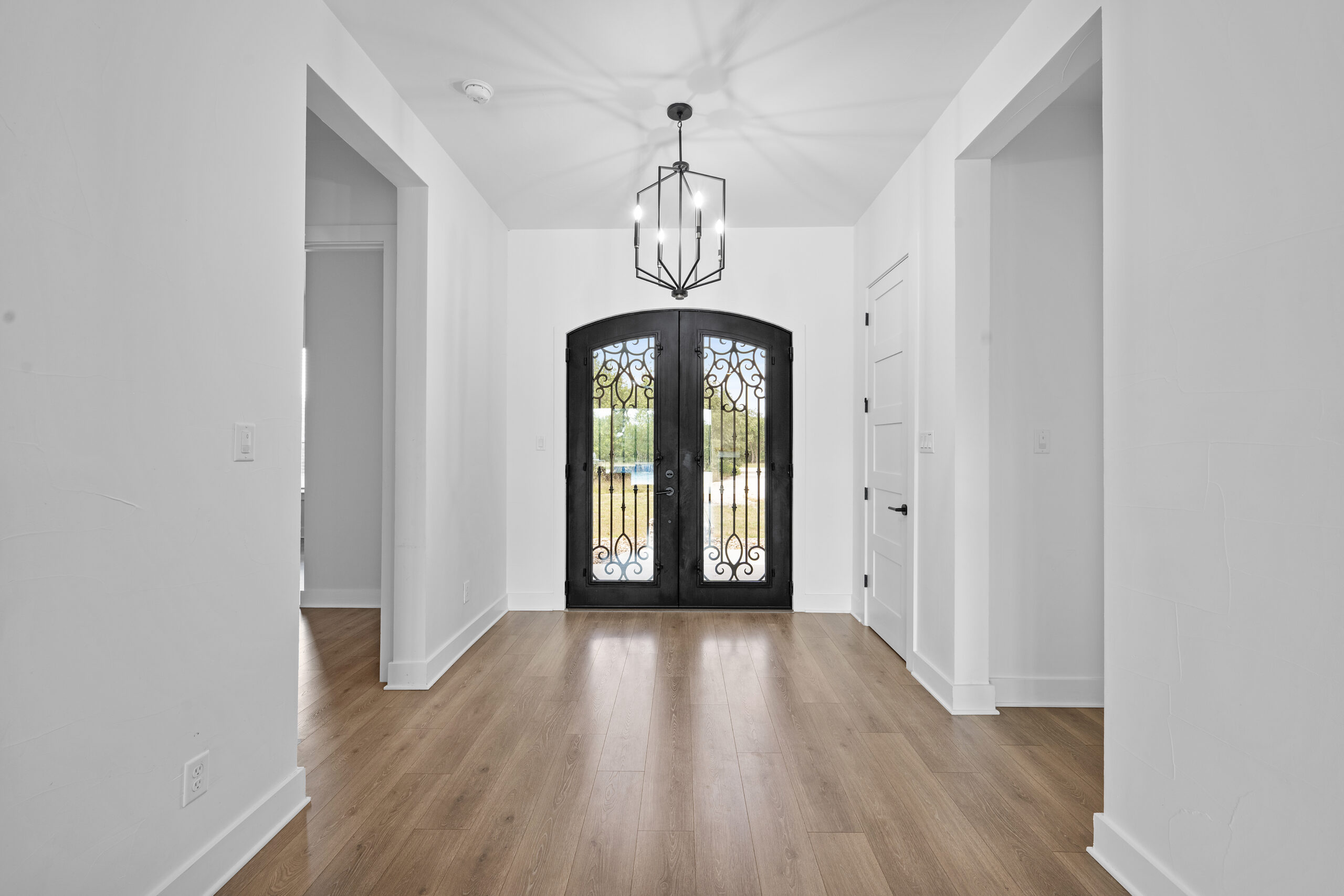 Luxury home entrance with grand staircase and elegant interior photographed by ATXPhotoDude, a professional real estate photographer serving Central Texas.