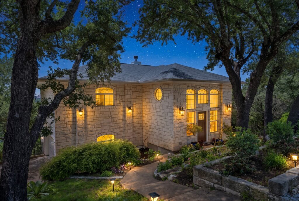 Lago Vista real estate photography featuring a luxury home's front exterior during blue hour twilight with professional architectural lighting.