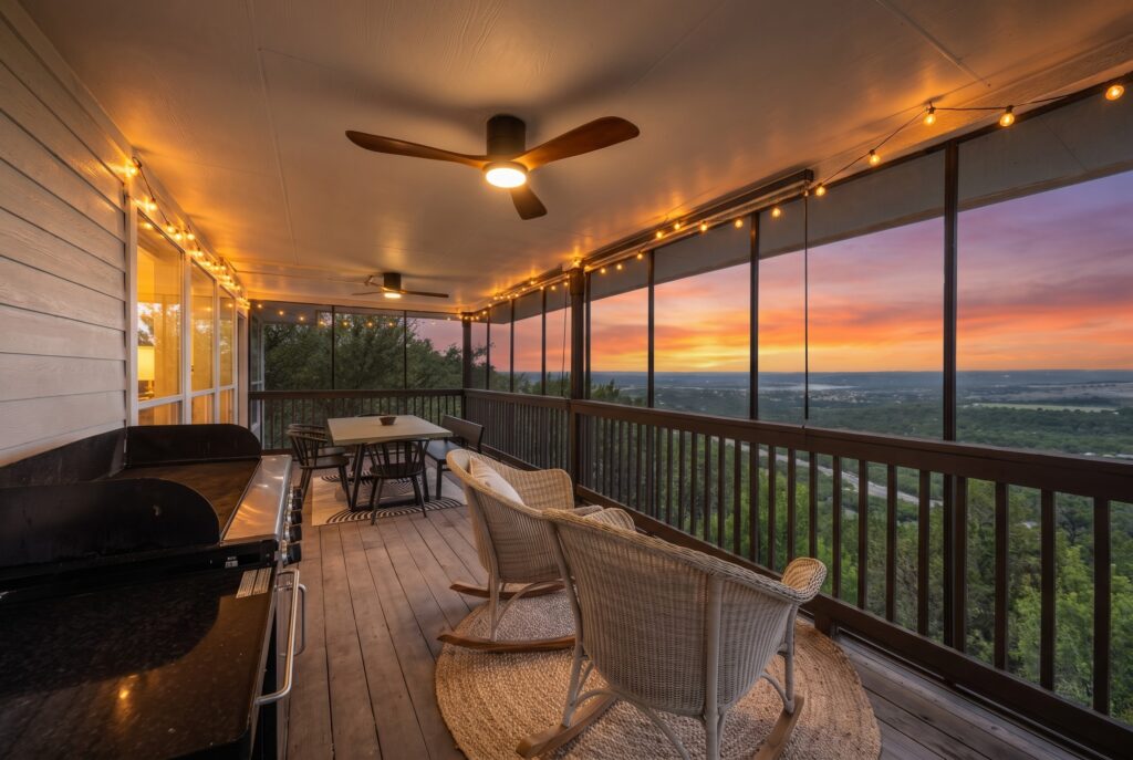 Lago Vista real estate photography featuring a luxury deck at twilight overlooking Lake Travis and the Texas Hill Country.