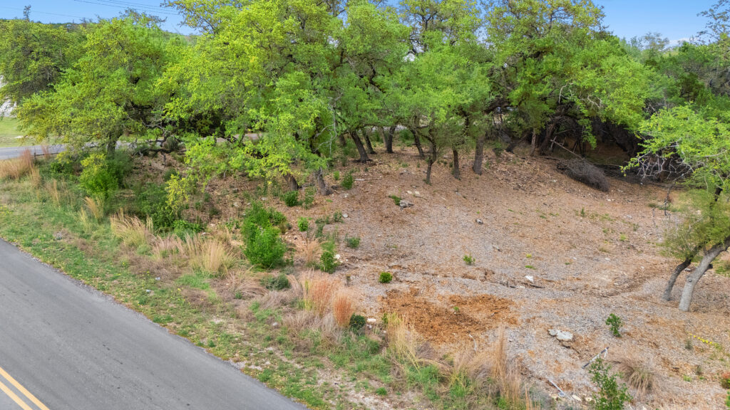 Lago Vista real estate photographer featuring a drone aerial view of a residential land lot surrounded by the Texas Hill Country near Lake Travis.