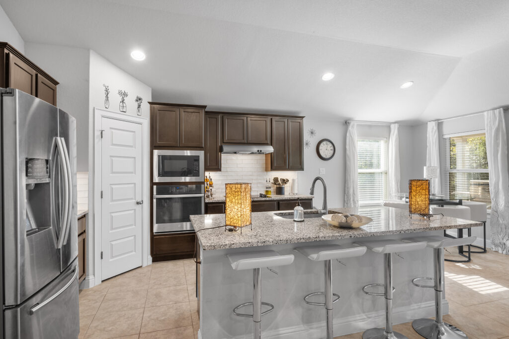 Lago Vista real estate photography featuring a modern luxury kitchen with custom cabinetry, natural light, and professionally captured interior photography.