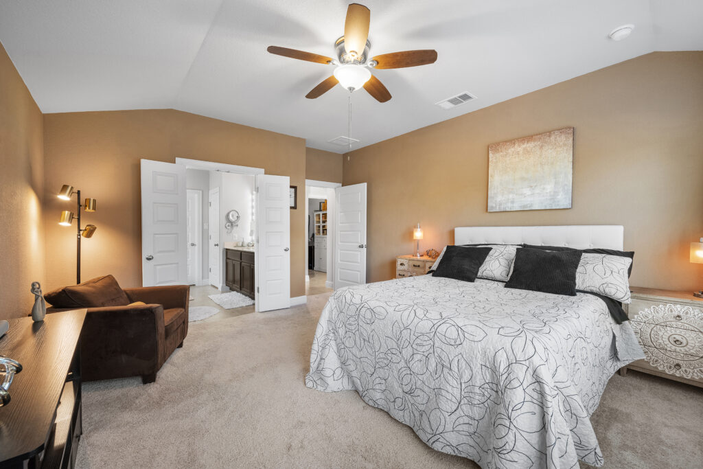Lago Vista real estate photography featuring a luxurious primary bedroom with elegant finishes, abundant natural light, and professionally captured interior photography.