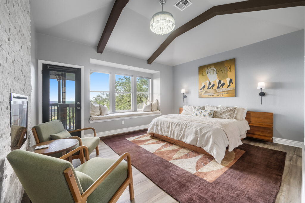Lago Vista real estate photography featuring a luxurious primary bedroom with elegant finishes, abundant natural light, and professionally captured interior photography.