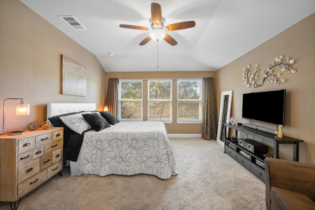 Lago Vista real estate photography featuring a spacious primary bedroom with modern finishes, natural light, and professionally captured interior photography.