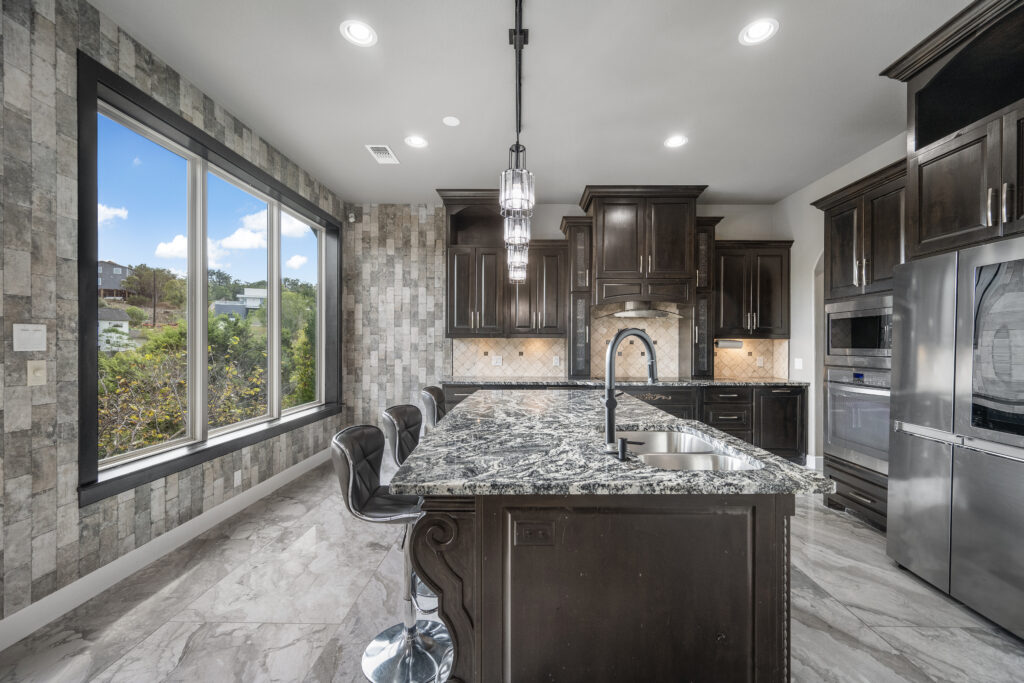 Luxury kitchen overlooking Lake Travis photographed by ATXPhotoDude, a professional real estate photographer specializing in waterfront and luxury home photography.