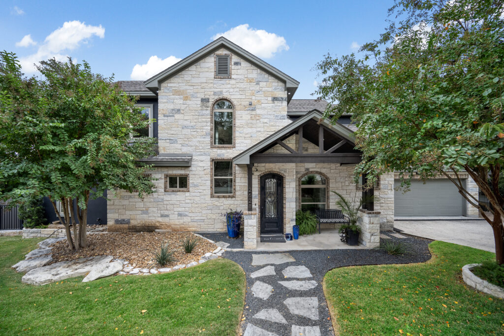 Front exterior of a luxury Lake Travis home photographed by ATXPhotoDude, a professional real estate photographer specializing in waterfront and luxury properties.