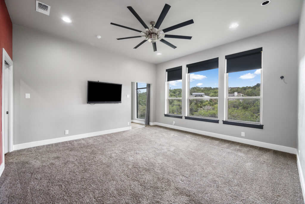Primary bedroom with breathtaking Lake Travis views photographed by ATXPhotoDude, a professional real estate photographer specializing in luxury waterfront properties.