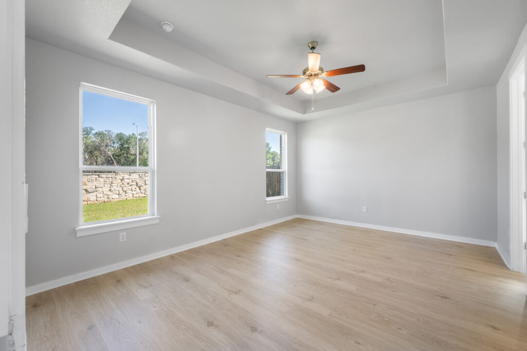 Luxury primary bedroom real estate photography in Liberty Hill Texas