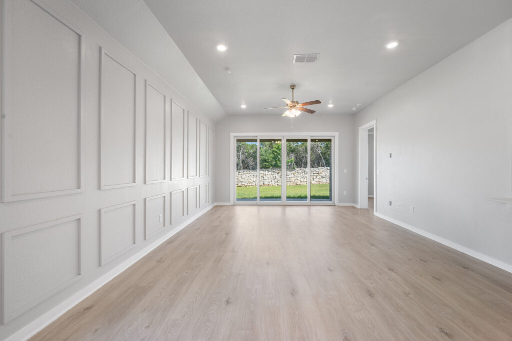 Luxury living area with decorative wall moulding real estate photography in Liberty Hill Texas