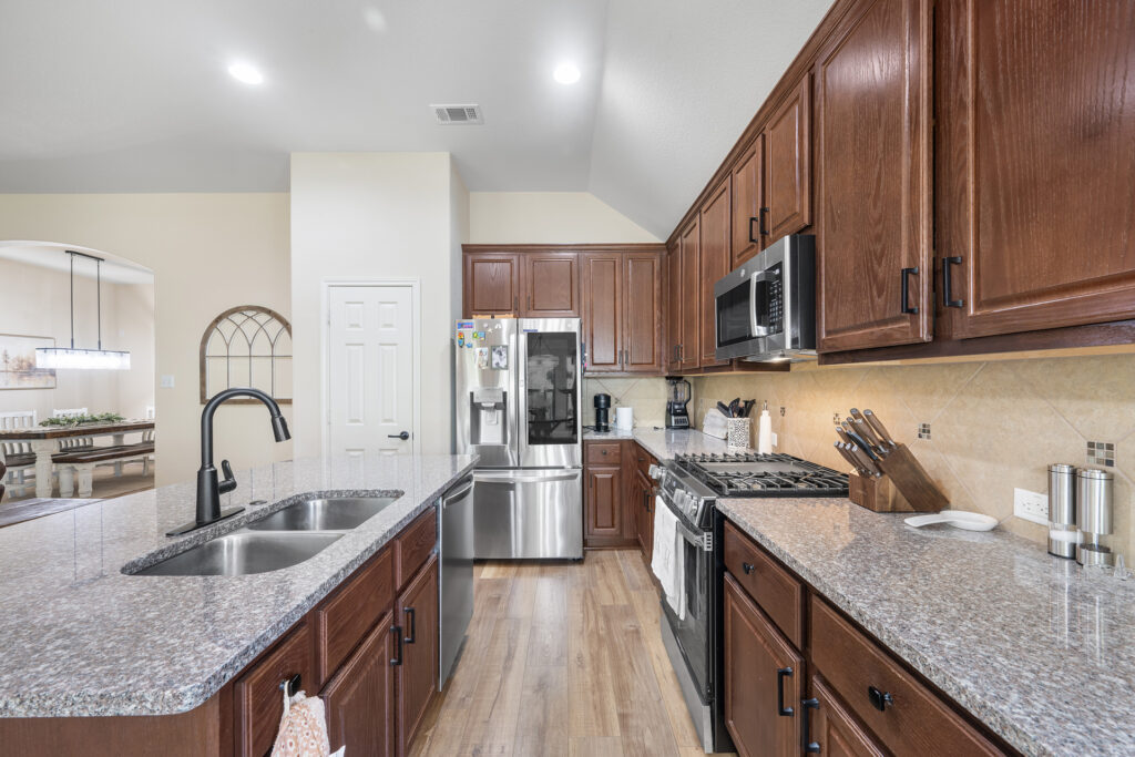 Luxury kitchen island with granite countertops real estate photography in Liberty Hill Texas