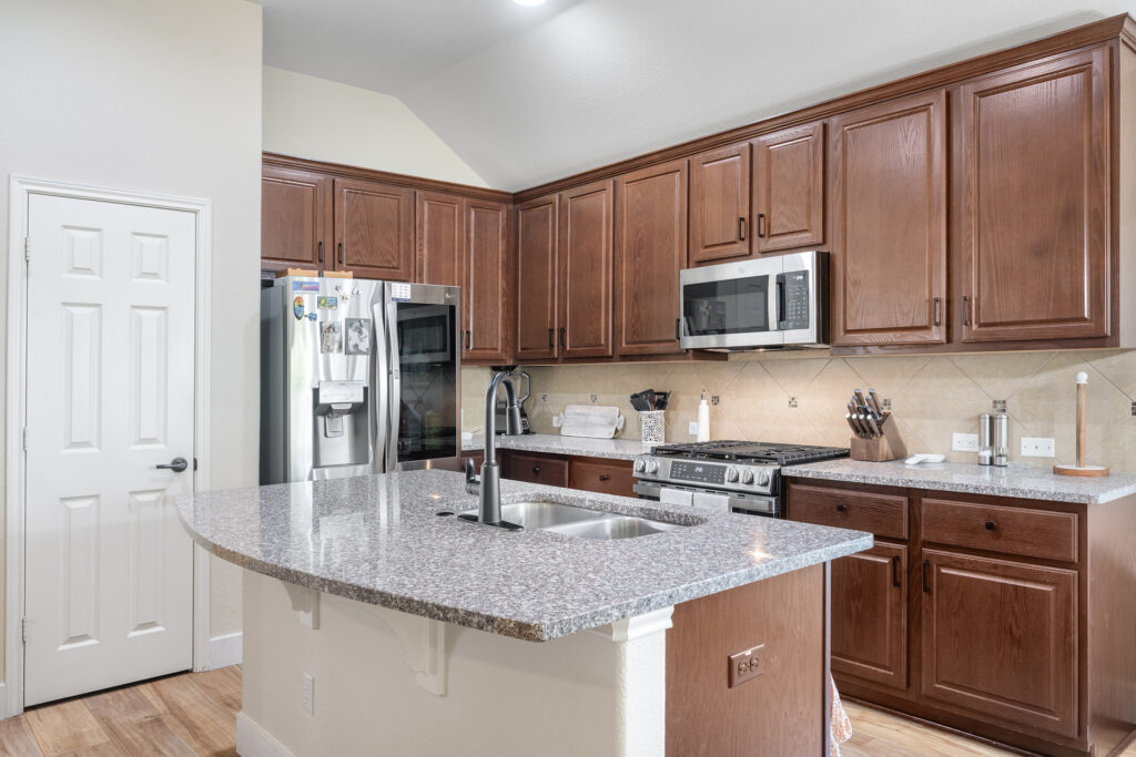 Luxury kitchen with brown cabinets real estate photography in Liberty Hill Texas