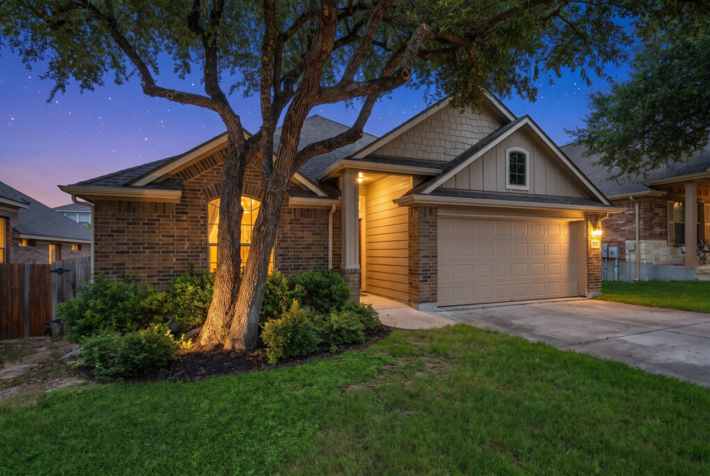 Twilight front exterior real estate photography with a pink sunset sky in Liberty Hill Texas