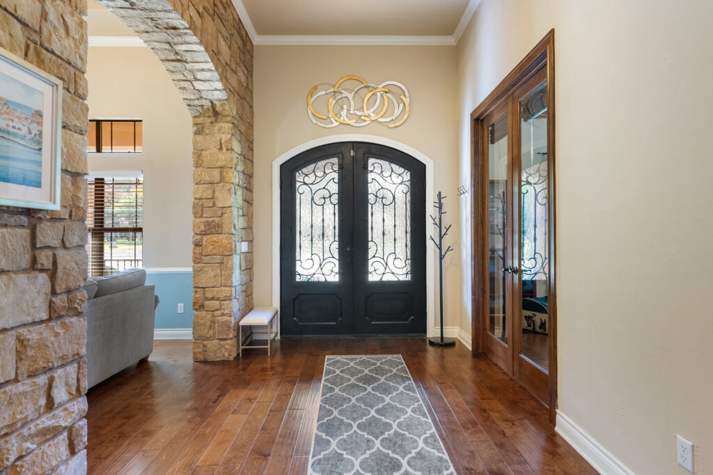 Grand luxury home entrance photographed by ATXPhotoDude, a professional real estate photographer specializing in high-end residential photography.