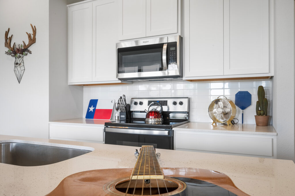 Short-term rental kitchen with guitar real estate photography in Round Rock Texas