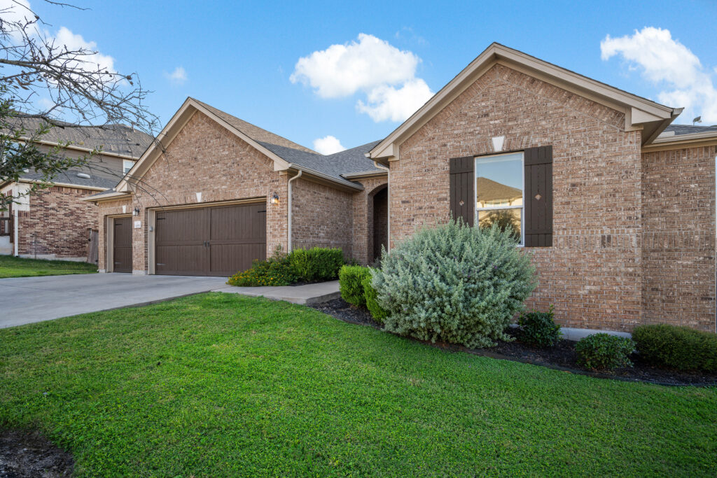 Front exterior of a beautiful Round Rock home photographed by ATXPhotoDude, a professional real estate photographer specializing in high-quality listing photography.